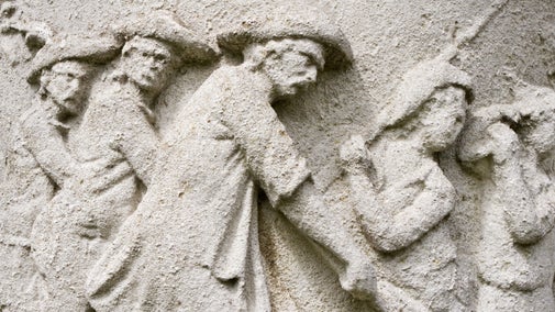 Close-up view of a relief on an ornamental urn at Polesden Lacey, Surrey, depicting men in uniform.